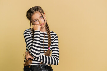 Tired bored preteen child girl kid indifferent expression, exhausted of tedious story, not interested in communication talk, displeasure, uninteresting. Teenager children isolated on beige background