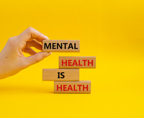 Mental Health symbol. Wooden blocks with words Mental Health is Health. Beautiful yellow...