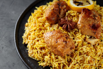 Chicken Biryani with Basmati Rice on Black Plate, Popular Indian and Pakistani Food, Close-up