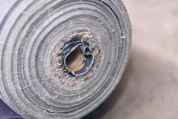 A roll of raw denim sheets fresh off a production line in a denim factory. Industrial fabric and fashion manufacture. Stylish blue denim fabric for wholesale and jeans. Iconic blue pants.