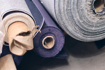 A roll of raw denim sheets fresh off a production line in a denim factory. Industrial fabric and...
