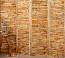 Bamboo room divider, interior design screen with natural texture. Wicker panel, rustic furniture,