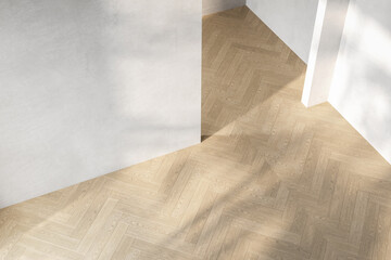 A room with a white wall and a wooden floor with a shadow on it