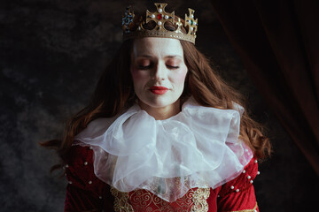 Fototapeta premium medieval queen in red dress with white collar and crown
