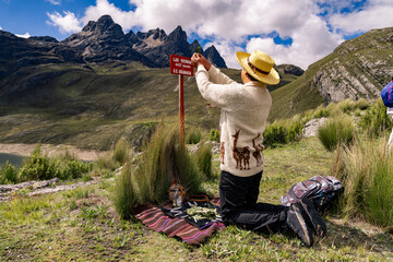 Andean man performing ritual of payment to the land in Peru, payment to the Pachamama