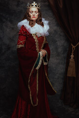 Full length portrait of medieval queen in red dress