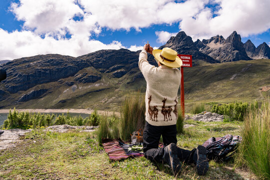 Andean man performing ritual of payment to the land in Peru, payment to the Pachamama