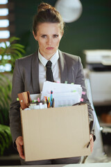 unhappy 40 years old woman worker in green office