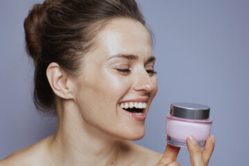 happy young female with cosmetic cream jar