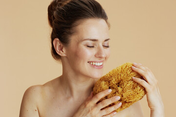 smiling young woman with sea sponge