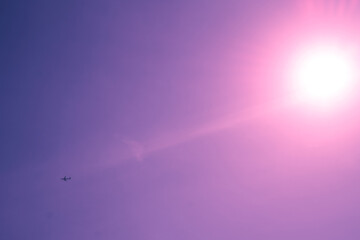 abstract light background, purple light effect, small airplane in the sky