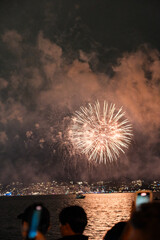 Sydney New Year's Spectacular: Orange Fireworks Bursting Through Clouds