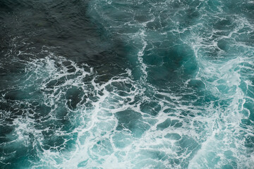 Moody Seascape: Dark Blue Waves Crashing with Dramatic Sky