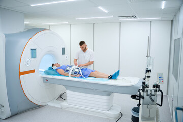 Male patient doing contrast-enhanced abdominal magnetic resonance imaging
