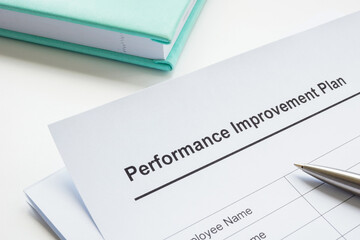Papers about performance improvement plan and pen.