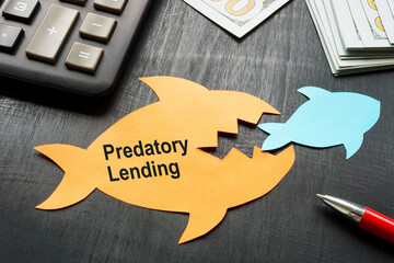 Predatory lending concept. Two paper fish on the office table.