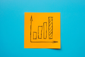 An orange sticker with a growing graph symbolizing business success, growth and increase.