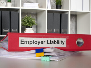 The folder Employer liability lies on a stack of papers.