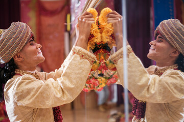 Young man at a ceremony doing a ritual with flower arrangements. Concept: religion, tradition