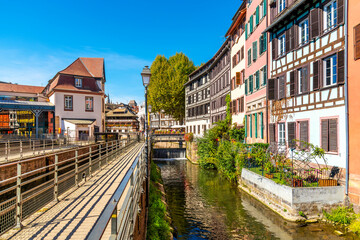 Fototapeta na wymiar Picturesque half timber, medieval waterfront buildings along the river Ill, in the Petite France district of the Alsatian city of Strasbourg, France.