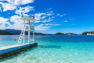 Lookout pier in the crystal clear bathing area of Bora Bora beach in the town of Ksamil-Albania