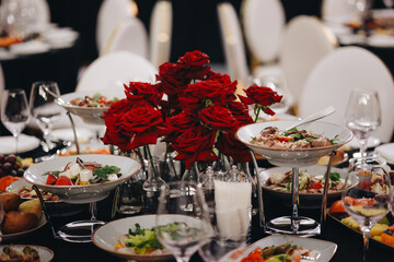 Beautifully organized event - round served table banquet ready for guests, round decorated table...
