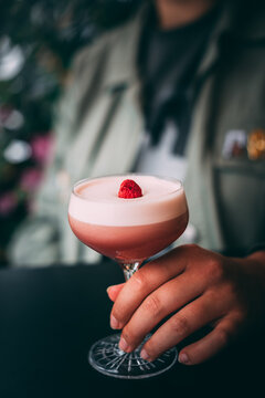Summer vibe cocktail in martini glass, decorated with berry