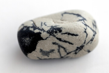White natural stone with black patterns. Isolated on white background