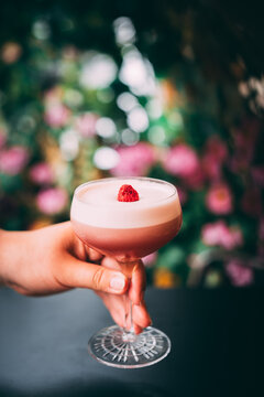 Summer vibe cocktail in martini glass, decorated with berry