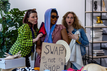 Group of friends generation z girls and boy enjoying shopping in a second hand store, trying hats,...
