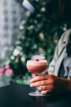 Summer vibe cocktail in martini glass, decorated with berry