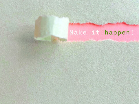 Inspirational Quote - Make it happen text behind torn paper background. Stock photo.