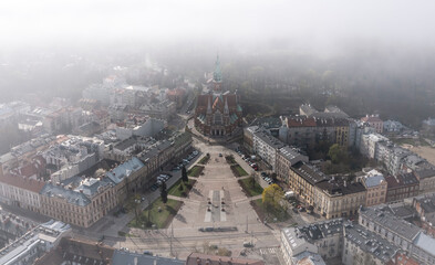 Aerial view of Podgorski Square with St. Joseph's Church during foggy morning in Podgorze District in Krakow, Poland