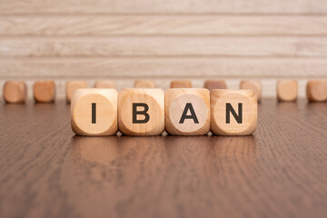 the text IBAN is written on wooden cubes on a brown background