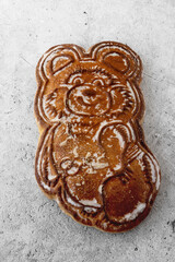 Gingerbread in the shape of a bear. Handmade Tula gingerbread on a gray background.