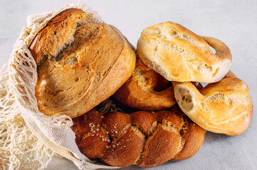 Assorted wheat and rye sourdough bread. Challah, kalachi, round rye bread in eco-friendly reusable containers. concept of love for bread, the fight against hunger in developing countries