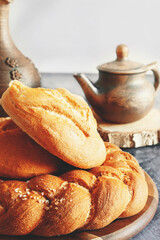 Kalach - traditional Lenten handmade bread on a rustic table illuminated by natural light from the window