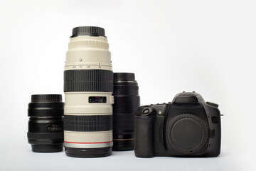 DSLR digital SLR camera with a set of lenses including macro, tele and wide angle, isolated on a white background - obrazy, fototapety, plakaty