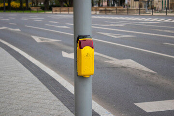 Crosswalk. Yellow button on a traffic light for pedestrians