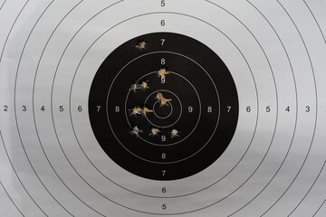 Paper target for shooting with holes from 45 caliber pistol bullets.