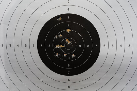 Paper target for shooting with holes from 45 caliber pistol bullets.