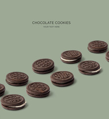 Creative layout made of chocolate cookies on the green background. Food concept. Macro concept.