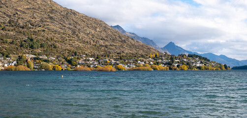 A panoramic view of Kelvin Peninsula of Queenstown in autumn, adorned with golden trees. It is located on the shore of Lake Wakatipu and is one of the most expensive suburbs in New Zealand.