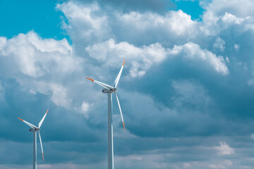 Windmills set on a cloudy sky background.Natural renewable clean eco energy. Alternative energy sources.Environmentally friendly natural energy source. 