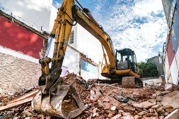 Excavator demolishing building.
