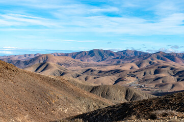 Panoramic view on colourful remote basal hills and mountains of Massif of Betancuria as seen from observation point, Fuerteventura, Canary islands, Spain