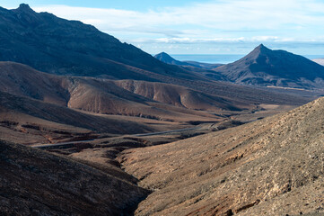Panoramic view on colourful remote basal hills and mountains of Massif of Betancuria as seen from observation point, Fuerteventura, Canary islands, Spain
