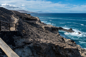 West coast of Fuerteventura island. View on blue water and black caves of Ajuy village, Canary...