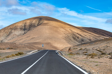 Mountain road on colourful remote basal hills and mountains of Massif of Betancuria, Fuerteventura, Canary islands, Spain