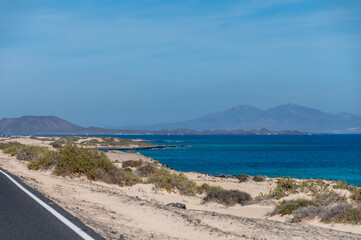 Caleta del bajo, corralejo grandes playas white sandy beach with blue water near Corralejo touristic town on north of Fuerteventura, Canary islands, Spain - obrazy, fototapety, plakaty